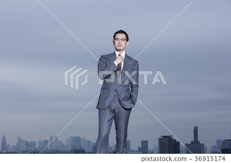 Businessman standing on the roof Businessman standing on the roof 36915174