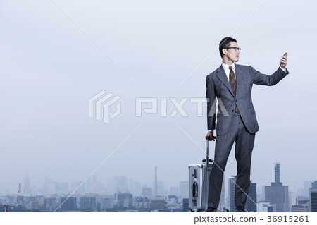 Businessman standing on the roof 36915261