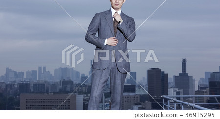 Businessman standing on the roof Businessman standing on the roof 36915295