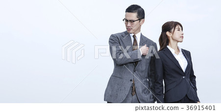 Businessman and businesswoman standing on the roof Businessman and businesswoman standing on the roof 36915401