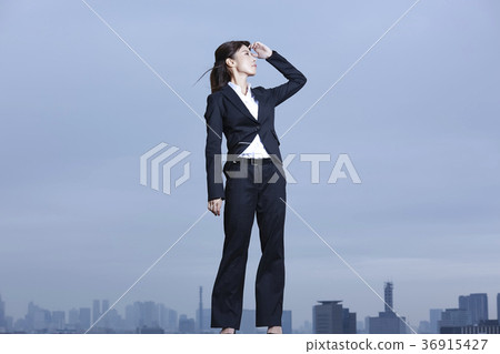 Business woman standing on the rooftop Business woman standing on the rooftop 36915427