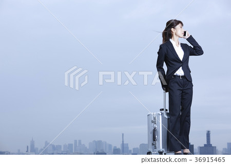Business woman standing on the rooftop Business woman standing on the rooftop 36915465