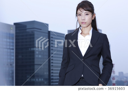 Business woman standing on the rooftop Business woman standing on the rooftop 36915603