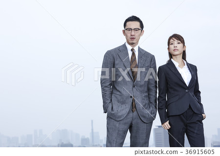 Businessman and businesswoman standing on the roof 36915605