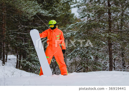 Snowboarder posing in winter forest Snowboarder posing in winter forest 36919441