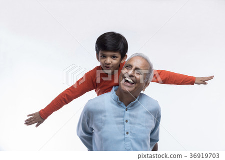 Boy sitting on grandfather's shoulders with arms Boy sitting on grandfather's shoulders with arms 36919703