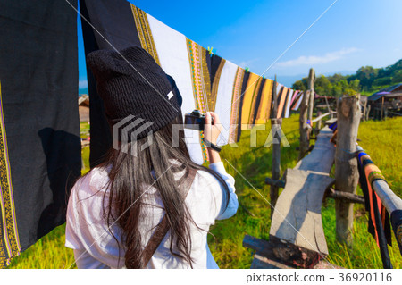 Asian woman taking photo colorful Thai sarongs Asian woman taking photo colorful Thai sarongs 36920116