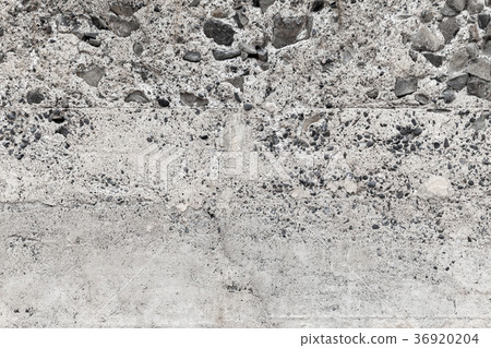 Rough concrete empty wall with stones 36920204