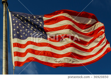 American flag blowing in the wind against  36920850