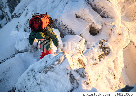 Woman hiker with backpack on the mountain top Woman hiker with backpack on the mountain top 36921060