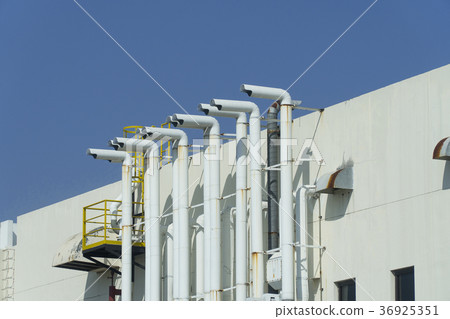 Several white ventilation vents the building Several white ventilation vents the building 36925351