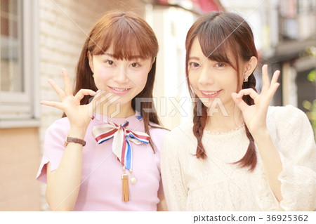 Two young women in the city sign OK Two young women in the city sign OK 36925362