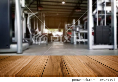 Wooden table on blurred background of fitness gym interior of mo 36925391