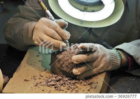 Researcher shaving a rock in a lab Researcher shaving a rock in a lab 36926777