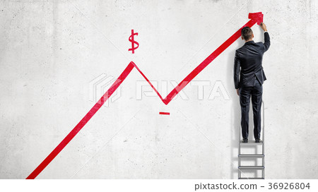 A businessman stands on a step ladder and draws a A businessman stands on a step ladder and draws a 36926804