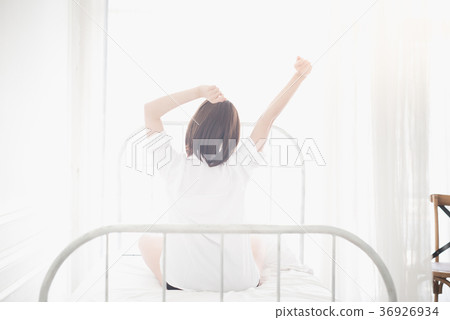 Beautiful Asian girl stretching on bed 36926934