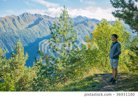 One tourist in shorts and a sweatshirt standing on One tourist in shorts and a sweatshirt standing on 36931180