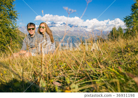 A boy with a girl in the mountains in the 36931198