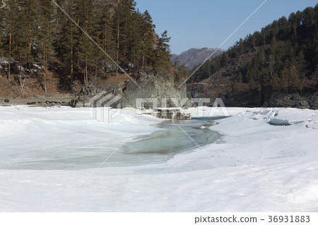Ice melting in the river in early spring 36931883