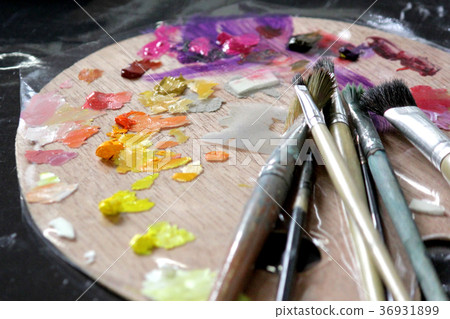 artists paint brushes on wooden palette 36931899