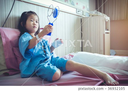 Illness asian child with saline iv drip on hand. Illness asian child with saline iv drip on hand. 36932105