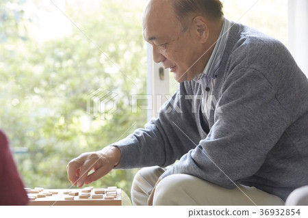 A child and senior playing a shogi 36932854