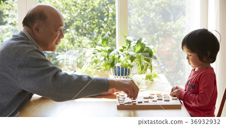 A child and senior playing a shogi 36932932