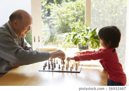Senior with child playing chess 36932987