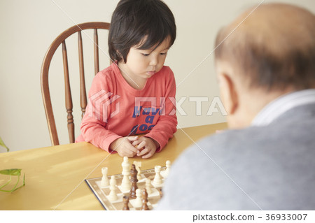 Senior with child playing chess Senior with child playing chess 36933007