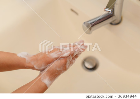A woman washing her hands 36934944