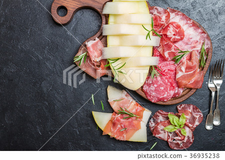 Italian ham, prosciutto and salami with melon. 36935238