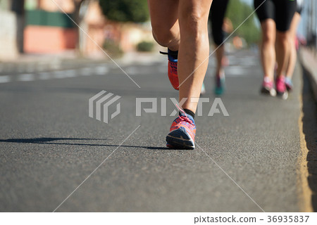 Marathon runners running on city road 36935837