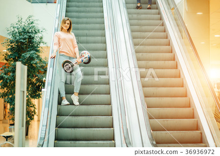 girl with hoverboard rides on the escalator girl with hoverboard rides on the escalator 36936972