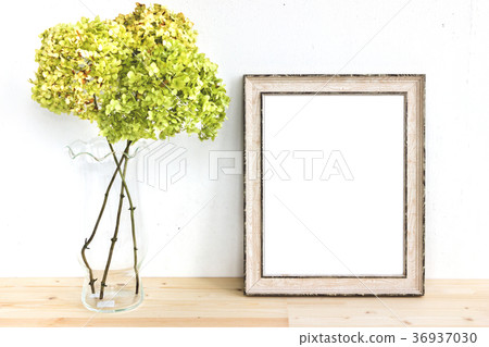 Wooden frame mockup with green flowers. Poster Wooden frame mockup with green flowers. Poster 36937030
