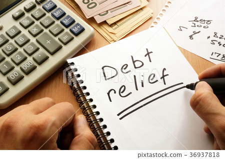 Note with words debt relief on a table. Note with words debt relief on a table. 36937818
