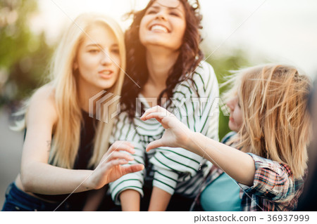 Adult sisters in a park at wonderful day making 36937999