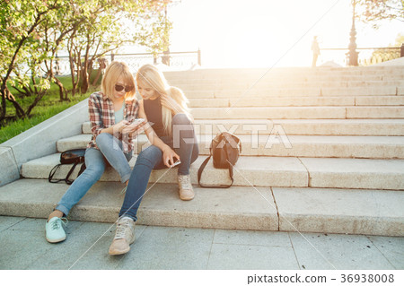 Two beautiful students watching media content on 36938008