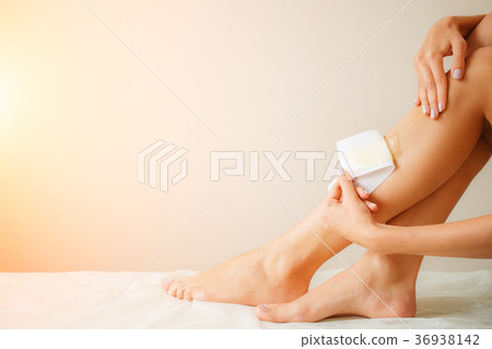 Long Woman Legs With Wax Strip On. Closeup Of Long Woman Legs With Wax Strip On. Closeup Of 36938142