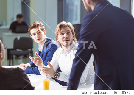 smiling male boss talking to business group smiling male boss talking to business group 36938582