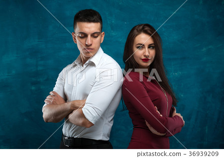 Young couple posing on blue background 36939209