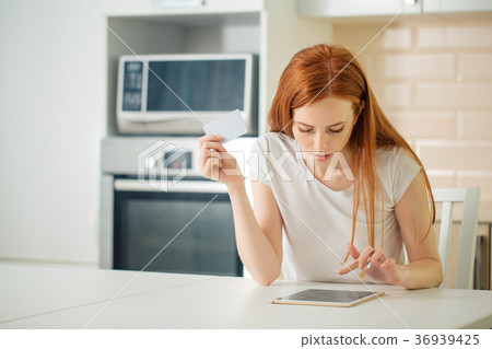 Woman is shopping online with tablet pc and Woman is shopping online with tablet pc and 36939425