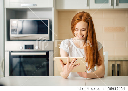 Happy woman working using digital tablet on desk 36939434