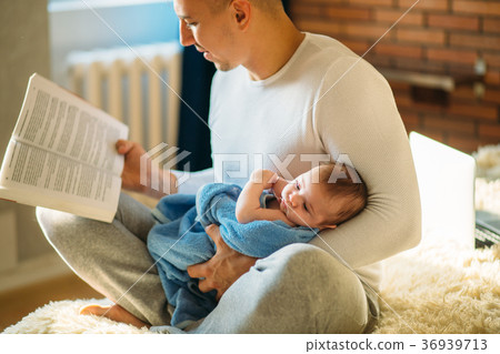 Young father and reading book to little baby Young father and reading book to little baby 36939713