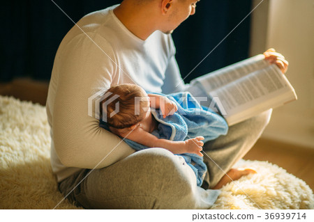 Young father and reading book to little baby Young father and reading book to little baby 36939714