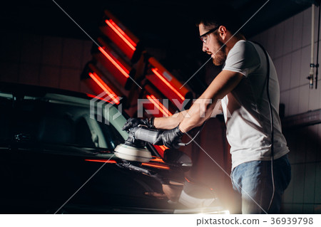 Car polish wax. worker hands holding a polisher 36939798
