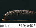 Black bread with seeds on dark background 36940407