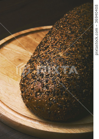 Black bread with seeds on dark background 36940408