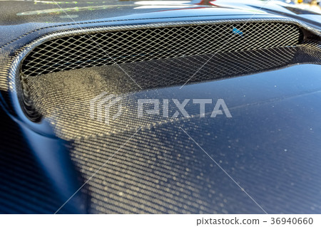 Carbon fiber texture on the hood of a car with Carbon fiber texture on the hood of a car with 36940660