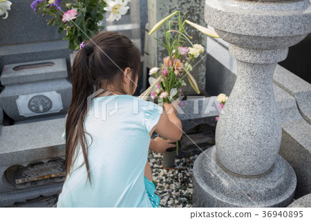 visiting a grave, younger, person 36940895