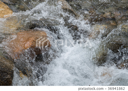 Strong boiling of water under mountain river 36941862